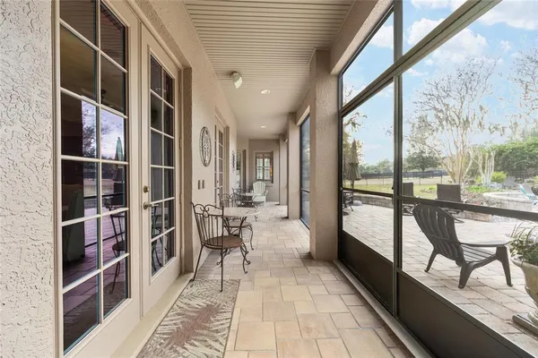 a view of a chair and table in backyard of the house