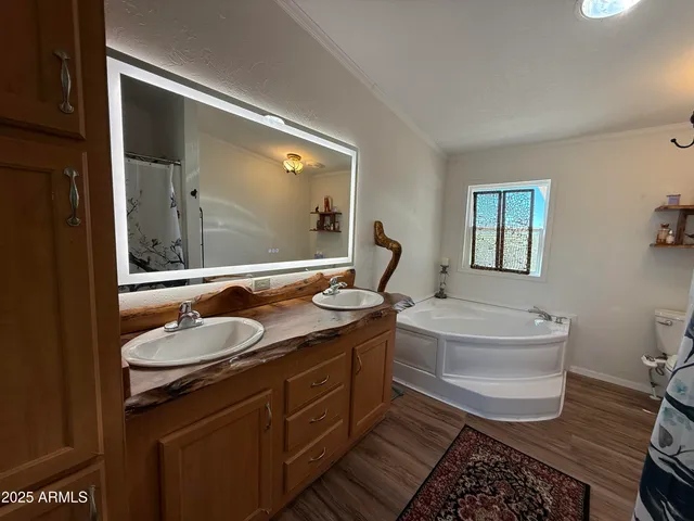 a white toilet sitting next to a bathroom sink and vanity