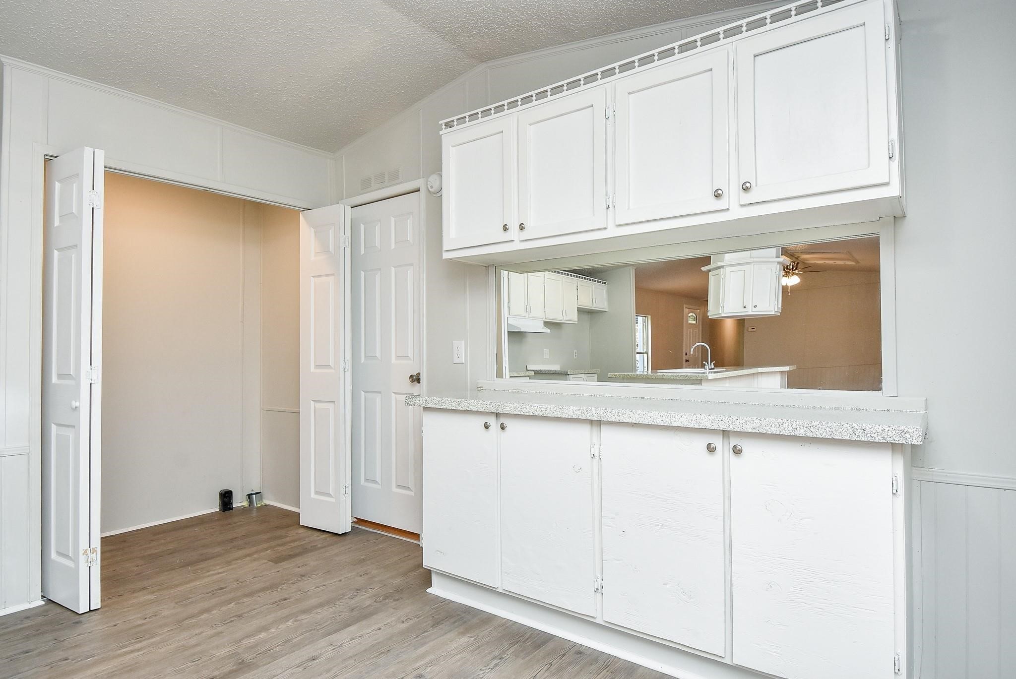 12842 Roy Harris Loop Conroe, TX 77306 - Photo 21 of 36 a kitchen with granite countertop white cabinets and a sink