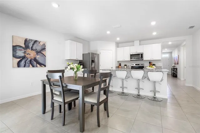 a view of a dining room with furniture and a potted plant