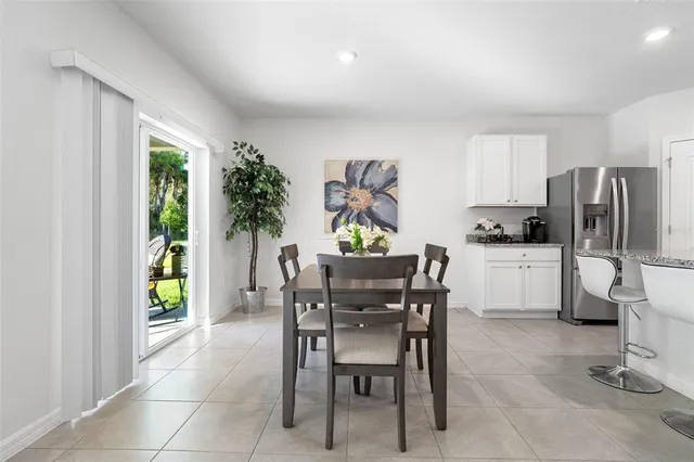 a kitchen with granite countertop white cabinets and stainless steel appliances