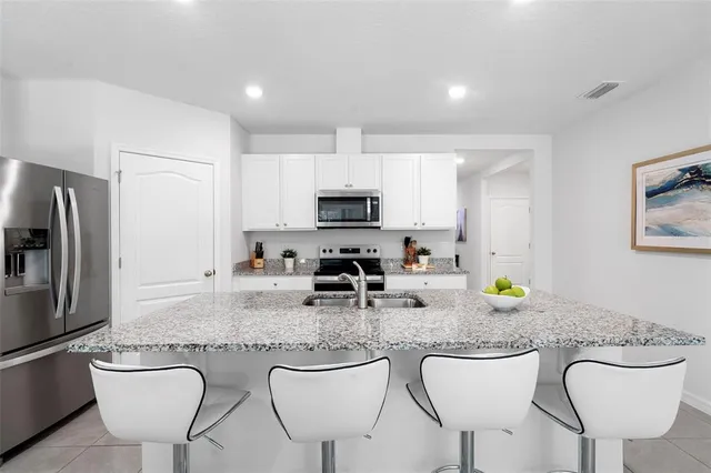a kitchen with a sink stove and refrigerator