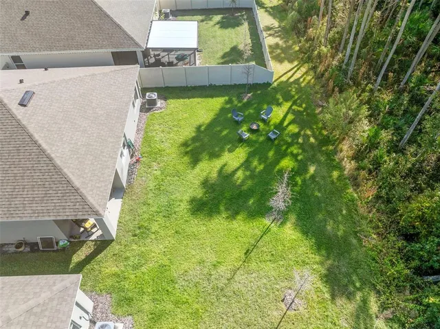 a backyard of a house with table and chairs