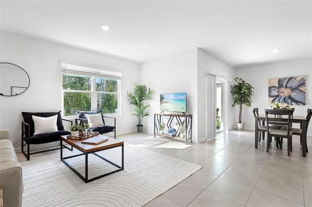 a living room with furniture and a large window