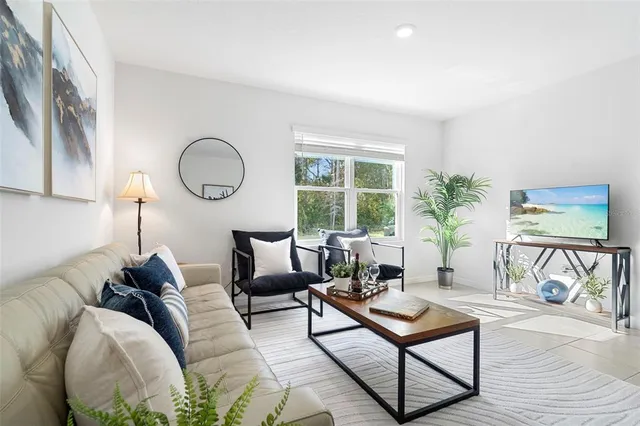 a living room with furniture and a large window