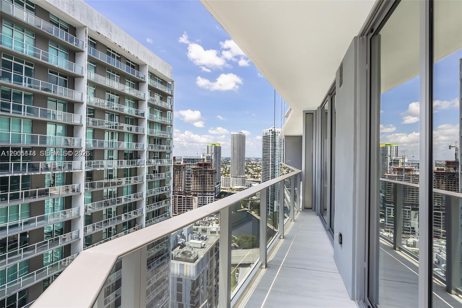 77 Southeast 5th Street, Unit 1815 Miami, FL 33131 - Photo 11 of 49 a view of balcony with a couple of cars parked in lobby