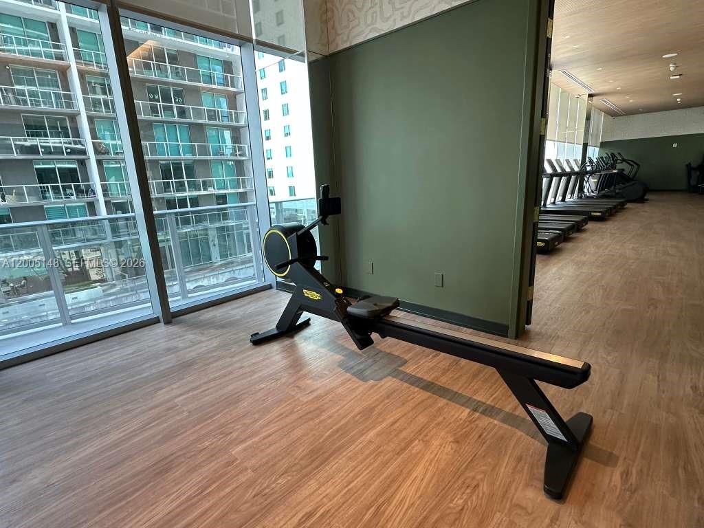 77 Southeast 5th Street, Unit 1815 Miami, FL 33131 - Photo 40 of 49 a view of a room with gym equipment