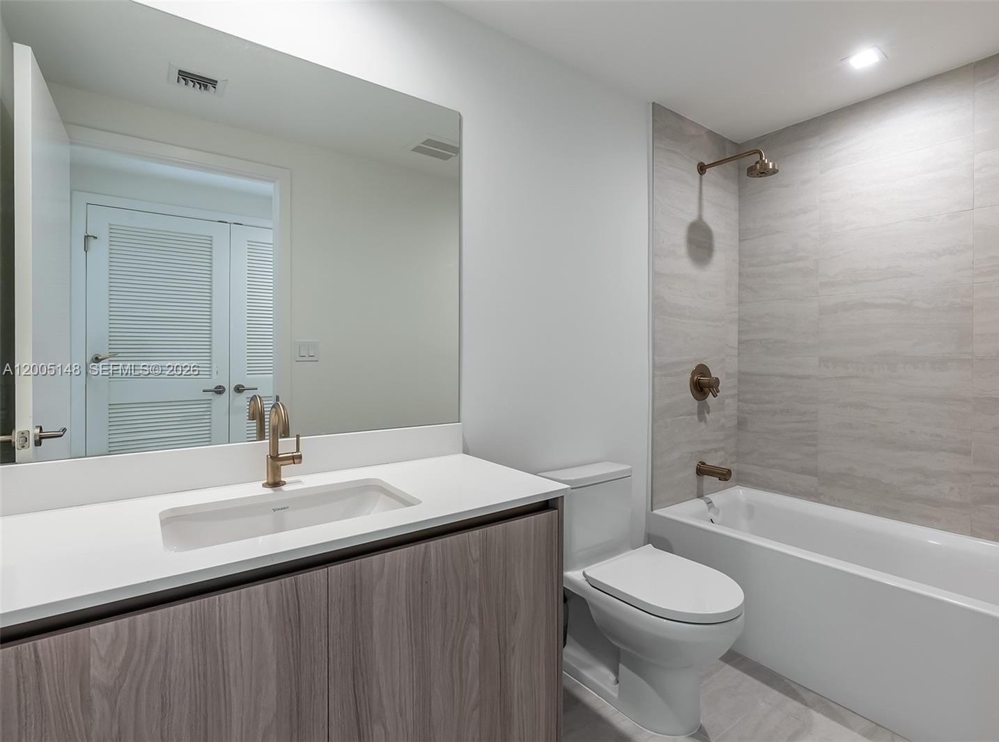 77 Southeast 5th Street, Unit 1815 Miami, FL 33131 - Photo 7 of 49 a bathroom with a sink a toilet and shower