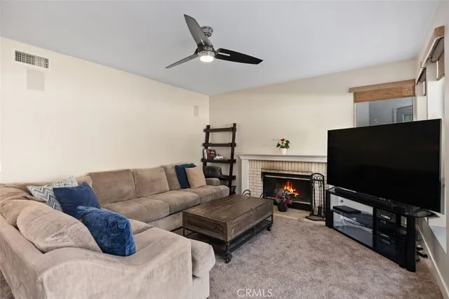a view of a living room a rug and a kitchen
