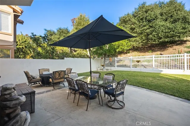 a view of a house with swimming pool and sitting area