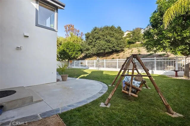 a front view of a house with a yard patio and swimming pool