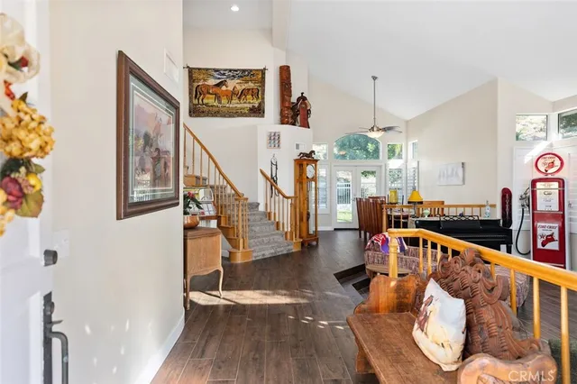 a living room with furniture a fireplace and a ceiling fan