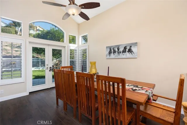 a view of a dining room with furniture and a chandelier