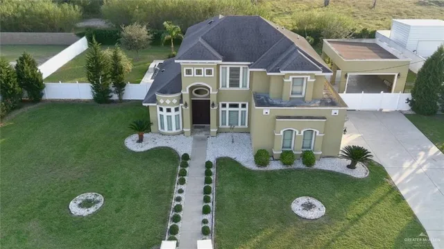 a aerial view of a house with a yard