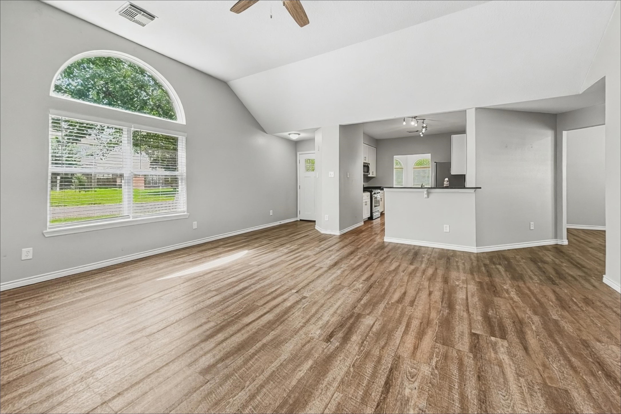 2423 Lofty Falls Court Spring, TX 77386 - Photo 7 of 15 an empty room with wooden floor and windows