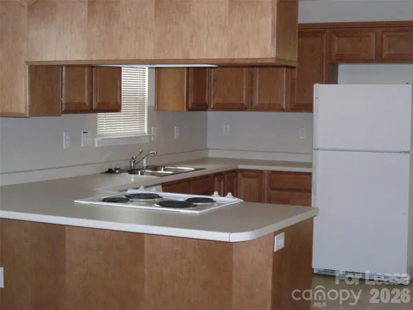 a kitchen with a sink a stove and a refrigerator