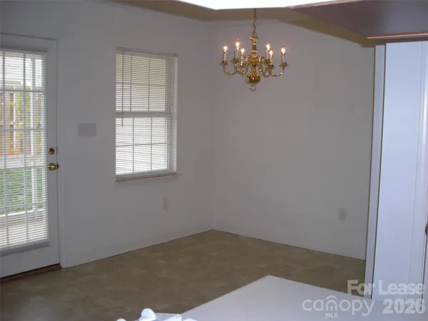 a view of a chandelier in big room and chandelier