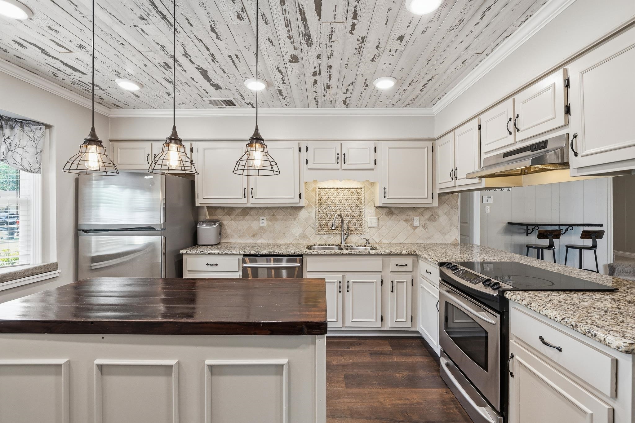 1234 Greenview Road Collierville, TN 38017 - Photo 10 of 33 a kitchen with kitchen island granite countertop white cabinets stainless steel appliances and a counter space