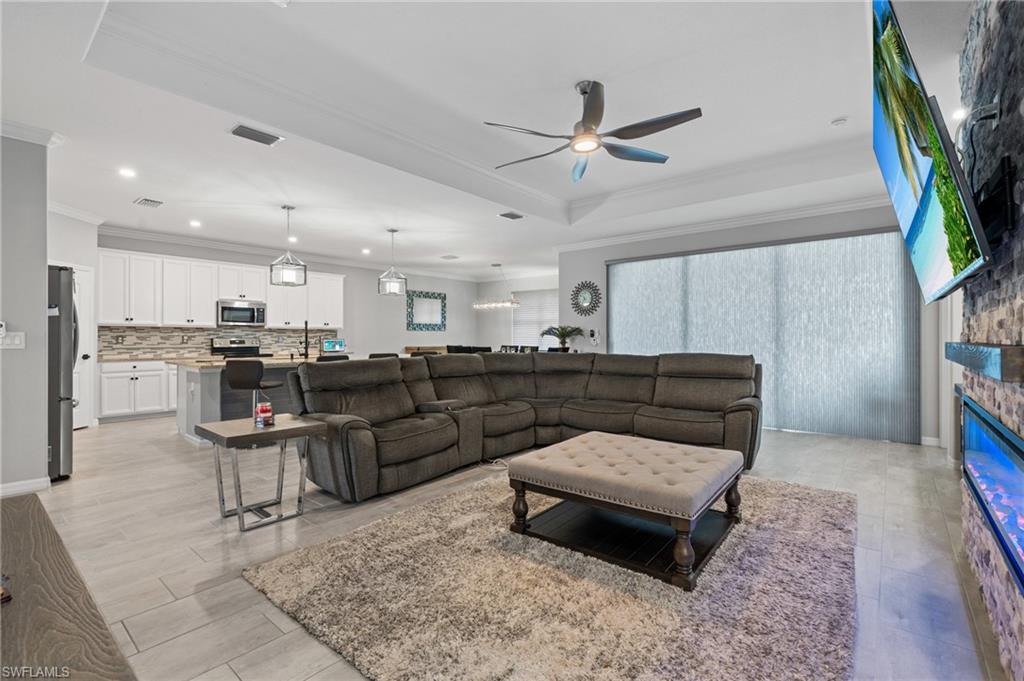19656 The Pl Boulevard Estero, FL 33928 - Photo 12 of 42 a living room with furniture and a dining table with kitchen view