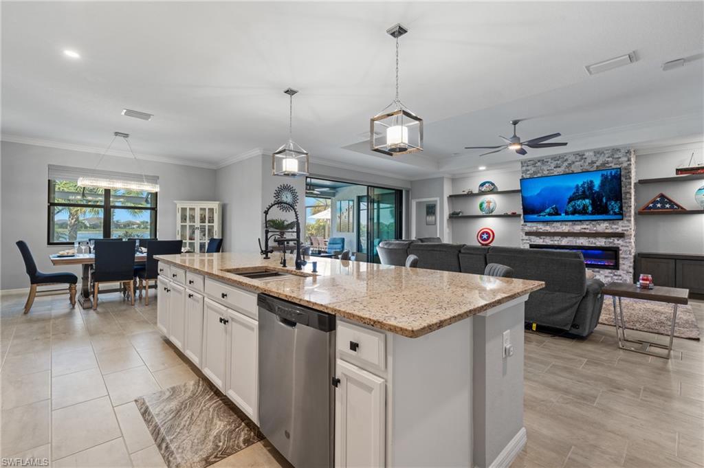 19656 The Pl Boulevard Estero, FL 33928 - Photo 15 of 42 a kitchen with stainless steel appliances granite countertop a sink a stove and a wooden floors