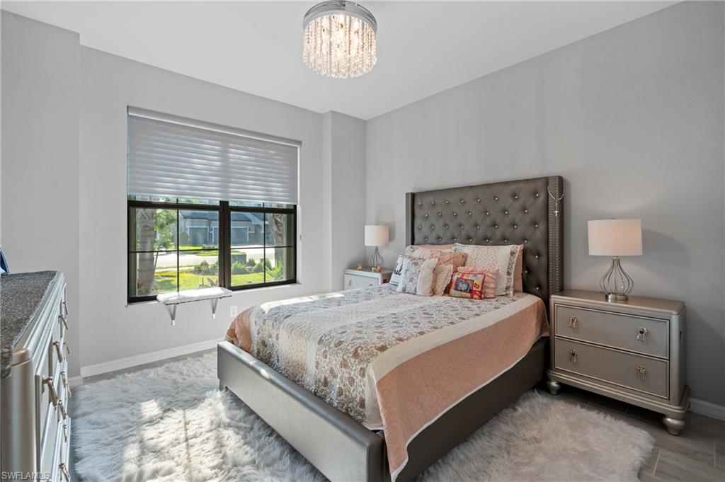 19656 The Pl Boulevard Estero, FL 33928 - Photo 21 of 42 a bedroom with a bed and a window