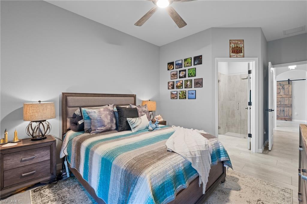 19656 The Pl Boulevard Estero, FL 33928 - Photo 23 of 42 a bedroom with a bed and a lamp