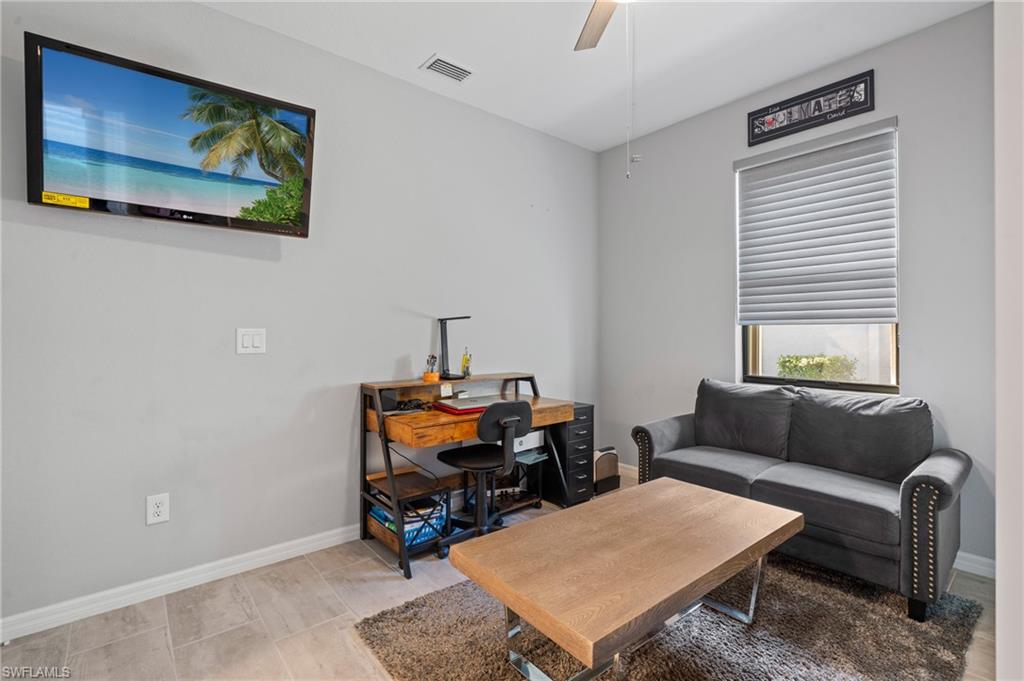19656 The Pl Boulevard Estero, FL 33928 - Photo 26 of 42 a living room with furniture a rug and a window