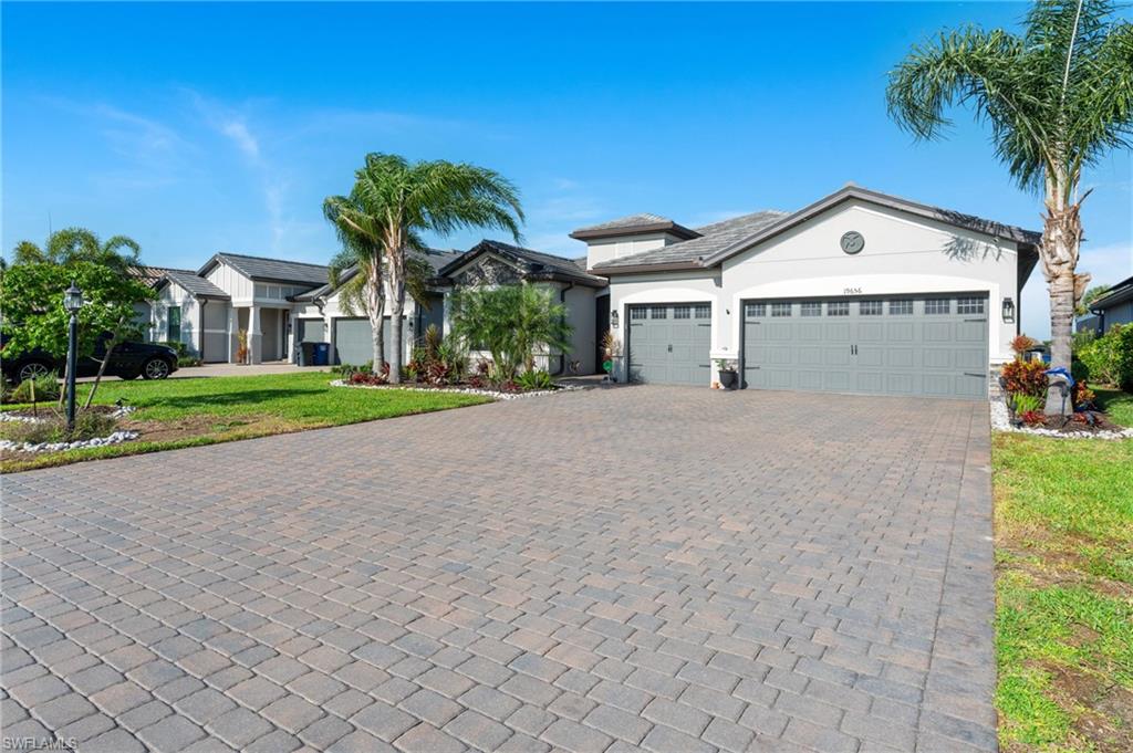 19656 The Pl Boulevard Estero, FL 33928 - Photo 30 of 42 a front view of a house with a yard and garage
