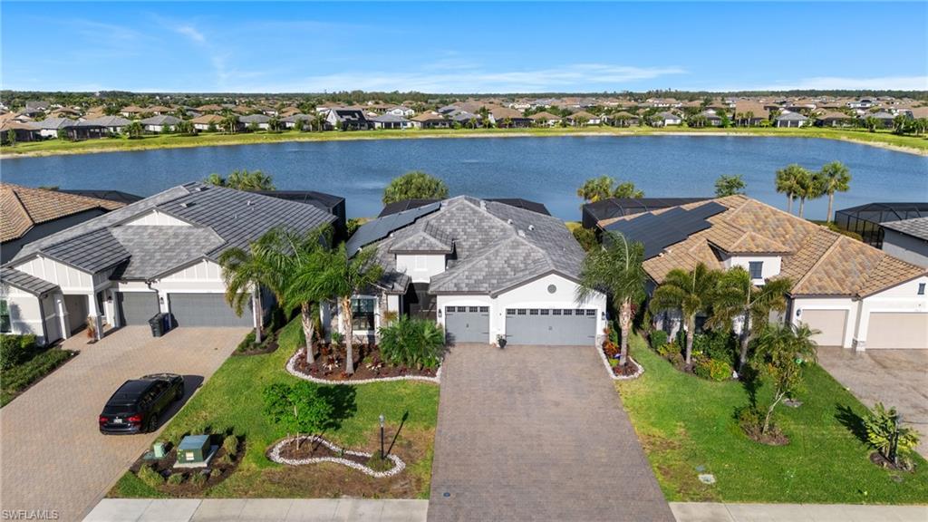 19656 The Pl Boulevard Estero, FL 33928 - Photo 32 of 42 an aerial view of a house with a garden and lake view