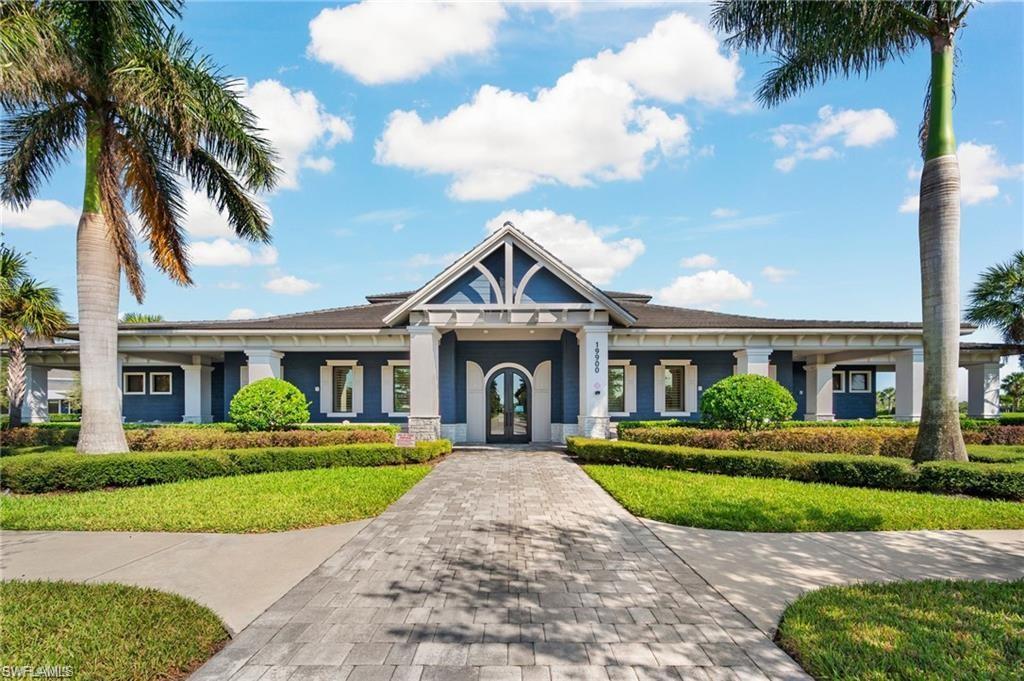 19656 The Pl Boulevard Estero, FL 33928 - Photo 39 of 42 a front view of a house with a yard and potted plants