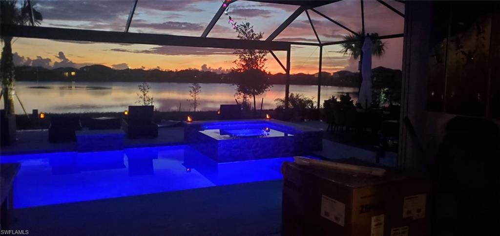 19656 The Pl Boulevard Estero, FL 33928 - Photo 4 of 42 a view of swimming pool with a table and chairs under an umbrella