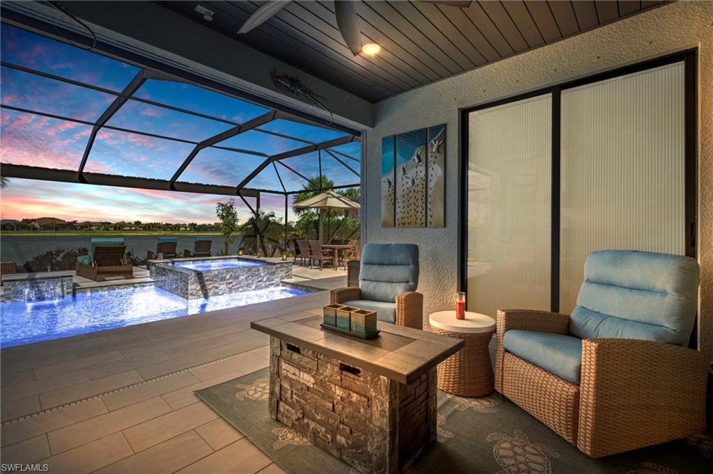 19656 The Pl Boulevard Estero, FL 33928 - Photo 5 of 42 a view of a patio with couches and chairs under an umbrella