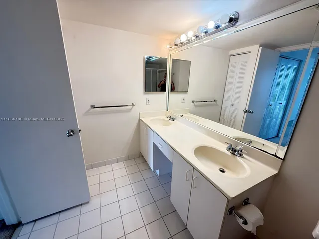 a bathroom with a sink a vanity and mirror