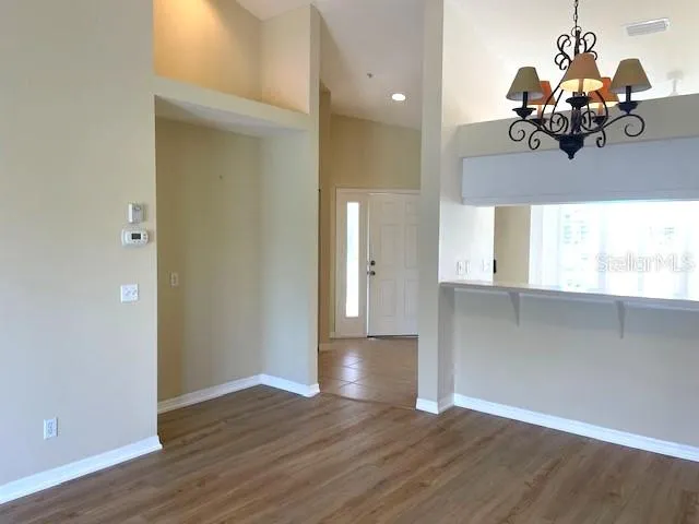 a view of a room with wooden floor