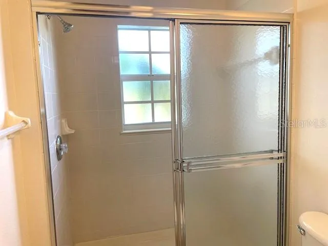 a bathroom with a glass shower door