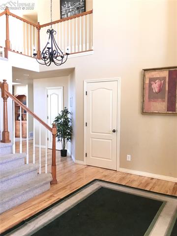 9275 Rockingham Drive Peyton, CO 80831 - Photo 3 of 26 Light-filled entry, Hardwood flooring.