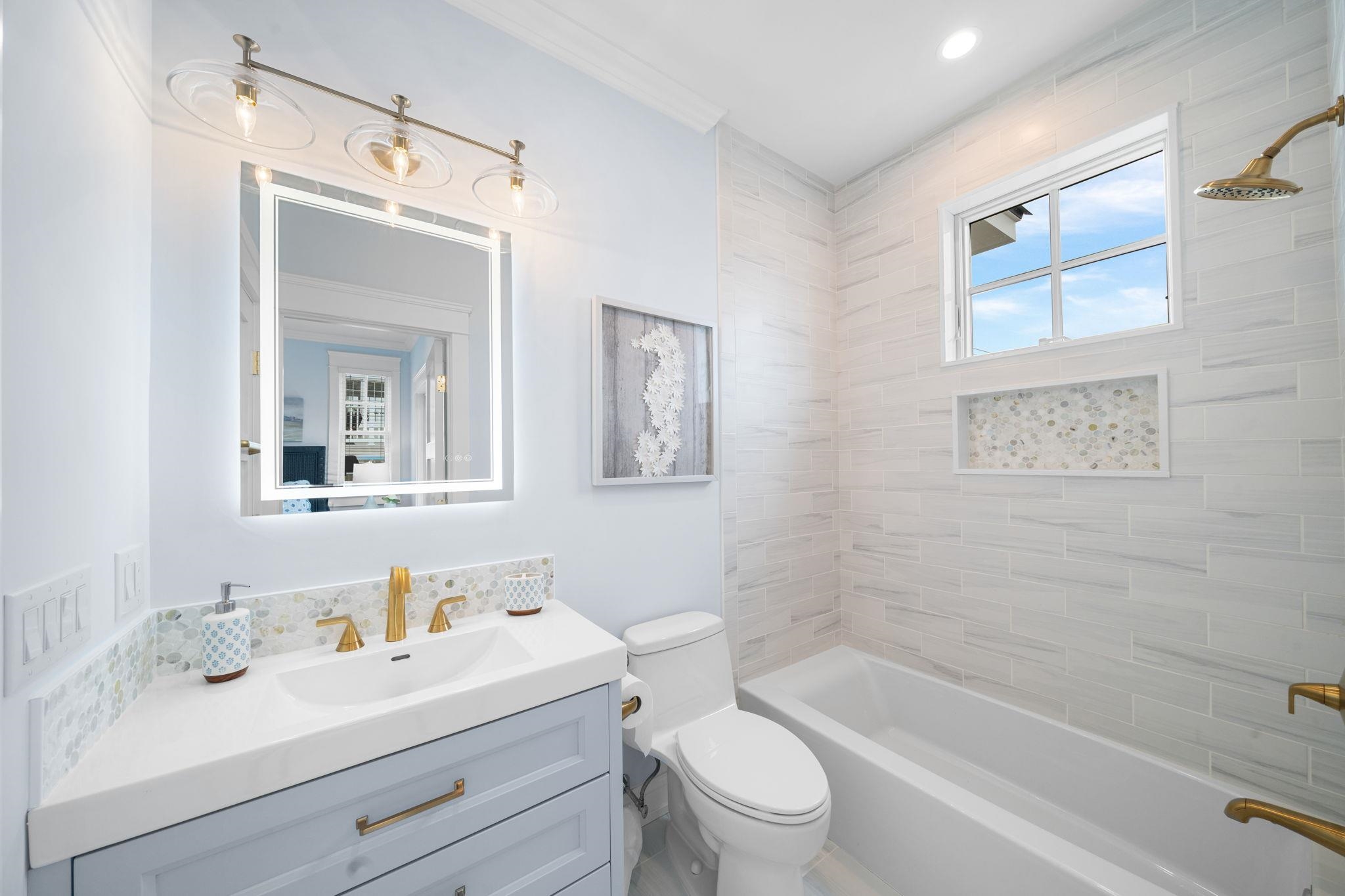 9102 3rd Stone Harbor, NJ 08247 - Photo 22 of 24 a bathroom with a bathtub shower sink vanity mirror and toilet