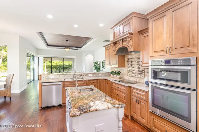 a kitchen with stainless steel appliances granite countertop a stove and a sink
