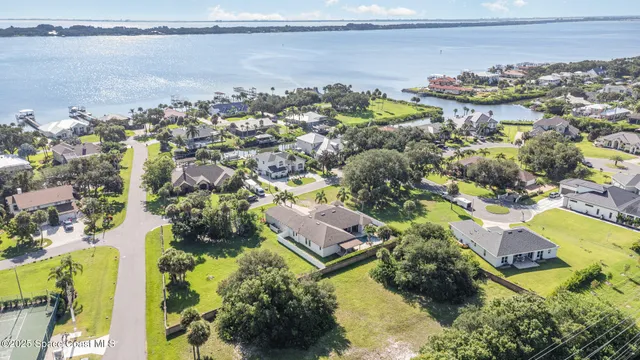 an aerial view of residential houses with outdoor space and swimming pool