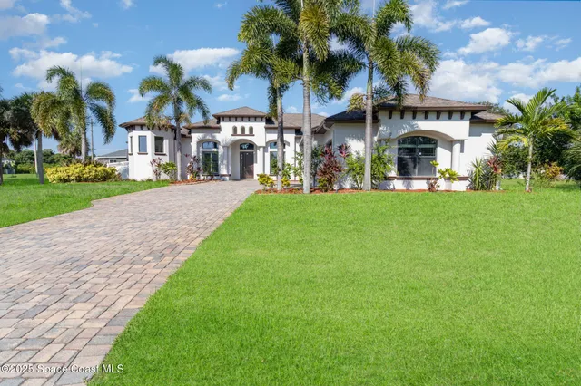 a front view of house with yard and green space