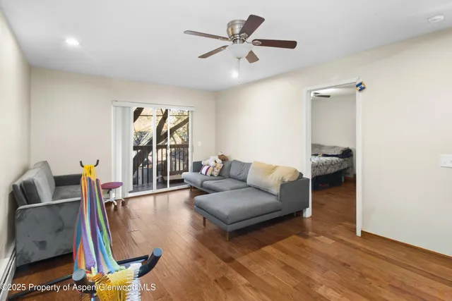 a living room with furniture and a wooden floor