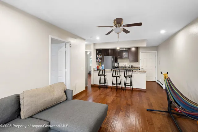 a living room with furniture and a wooden floor