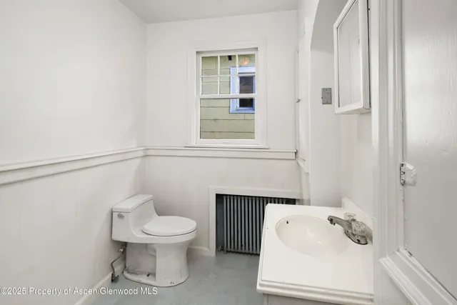a bathroom with a toilet and a sink