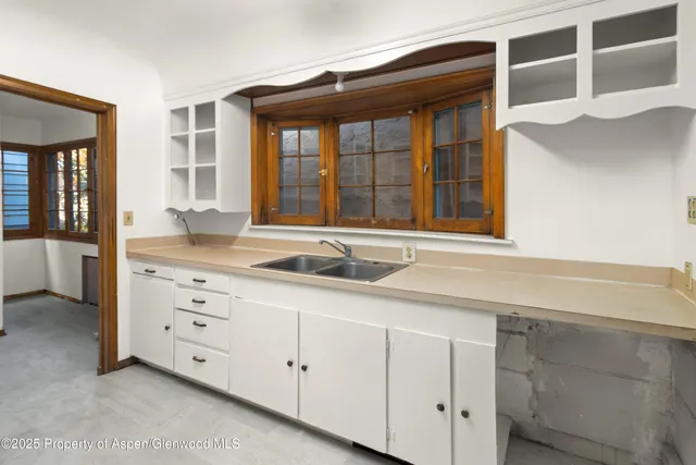 a kitchen with a sink and cabinets
