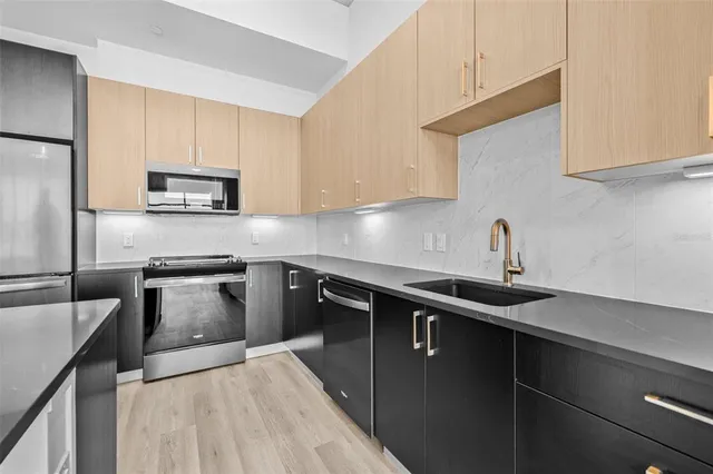 a kitchen with a sink stove and microwave