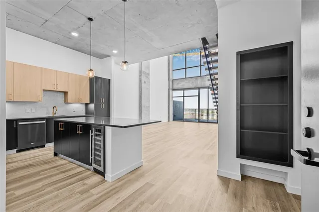 a kitchen with stainless steel appliances a refrigerator and a stove top oven
