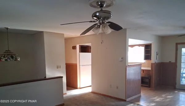 a view of a hallway with a refrigerator