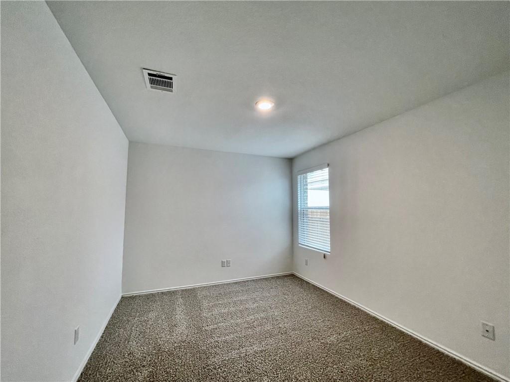 126 Canley Loop Hutto, TX 78634 - Photo 21 of 24 an empty room with windows