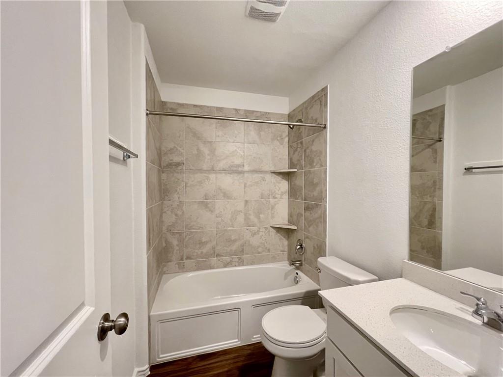126 Canley Loop Hutto, TX 78634 - Photo 22 of 24 a bathroom with a sink toilet and shower