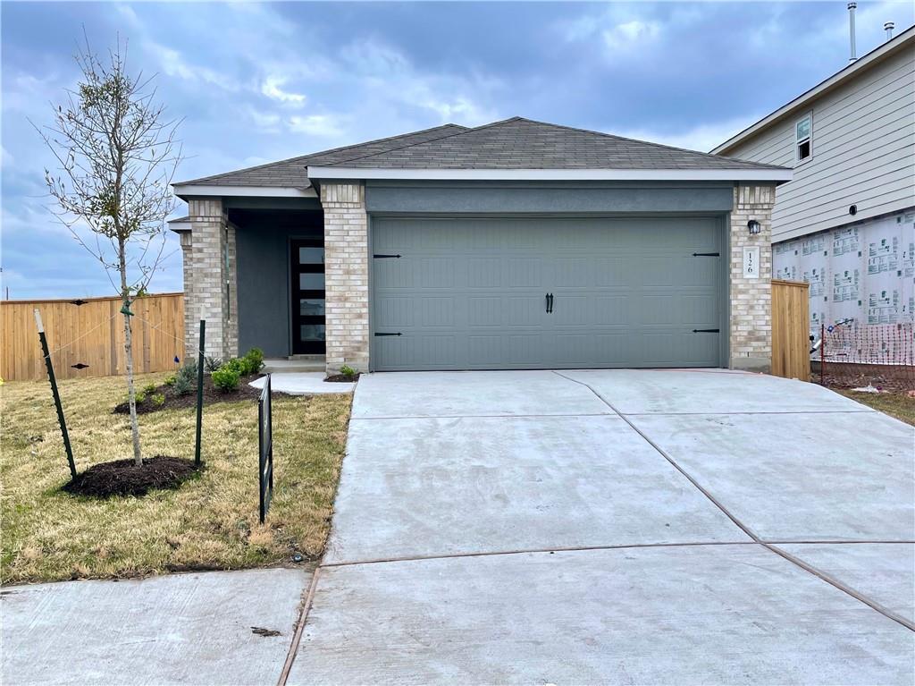126 Canley Loop Hutto, TX 78634 - Photo 3 of 24 a front view of a house with a garden